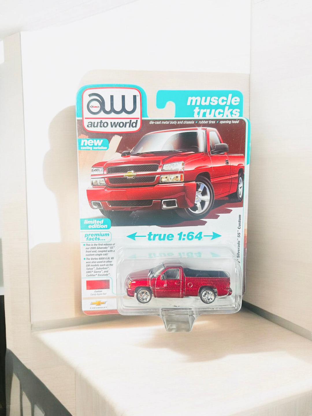 Auto World 1:64 2005 Chevrolet Silverado SS Custom Single Cab Version B – Candy Apple Red Metallic